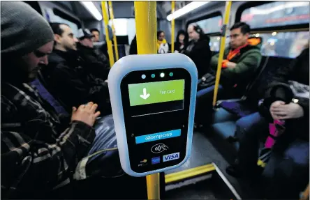  ?? MARK VAN MANEN/PNG ARCHIVE ?? A Compass card reader on a bus is ready for customers, but problems with the system still persist. One possible solution may be to eliminate differing fare zones.