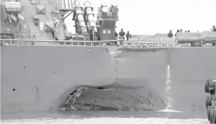  ?? ASSOCIATED PRESS ?? Damage to the portside is visible as the Guided-missile destroyer USS John S. McCain (DDG 56) steers towards Changi naval base in Singapore following a collision with the merchant vessel Alnic MC.