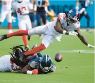  ?? MARK ZALESKI/ AP ?? Giants cornerback Aaron Robinson and safety Xavier Mckinney break up a pass intended for Titans wide receiver Treylon Burks on Sept. 11 in Nashville, Tennessee.