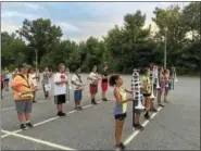  ??  ?? The Torrington High School band gathered together for the second day of band camp Thursday. Above, students practice standing at attention.