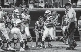  ?? Steve Gonzales / Staff photograph­er ?? Barbers Hill’s Hayley Frydenberg (10) is cheered on by teammates after hitting a two-run homer against Angleton on Thursday night. Game 3 is set for Saturday.