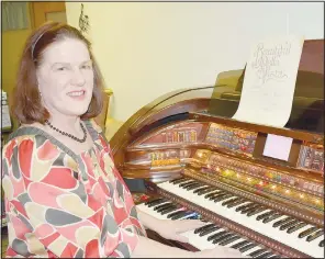  ?? (NWA Democrat-Gazette/Rachel Dickerson) ?? Marla Barina sits by an organ in her music studio in Bella Vista with a copy of the song “Beautiful Bella Vista,” which was written about the town in 1921. After looking into moving to Bella Vista in 2004, she learned she had a connection to the area.