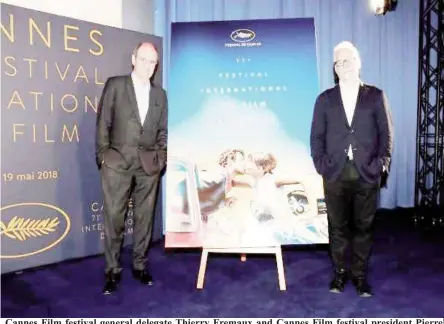  ??  ?? Cannes Film festival general delegate Thierry Fremaux and Cannes Film festival president Pierre Lescure (L) pose in front of the official poster for the 71st Cannes Film Festival after a news conference to announce the official selection, in Paris,...