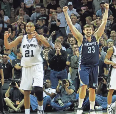  ?? NIKKI BOERTMAN/THE COMMERCIAL APPEAL ?? San Antonio Spurs center Tim Duncan (21) and Memphis Grizzlies center Marc Gasol (33) react as time expires and the Grizzlies defeat the top seed in the west, the Spurs, in Game 1 of their 2011 playoff series in San Antonio.