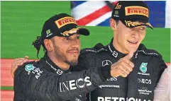  ?? AFP ?? Runner-up Lewis Hamilton, left, and champion George Russell, both of Mercedes, celebrate on the podium after the Brazlian Grand Prix last week.