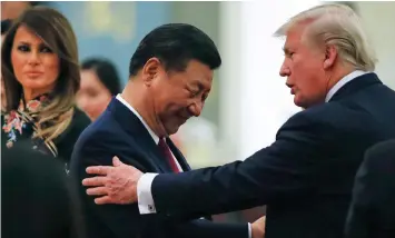  ?? THOMAS PETER AP ?? CHINA’S President Xi Jinping, US President Donald Trump and First Lady Melania Trump. The two sides are negotiatin­g an agreement with seven chapters that would be “the most significan­t change in the trading relationsh­ip in 40 years”. |