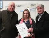  ??  ?? Pat Foley and Barry Curtin hnding the petition signed by more than 400 people to Catherine Darmody, the PA to Irish Water managing director Niall Gleeson.