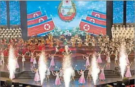  ?? NG HAN GUAN/AP ?? Putting on the ritz: Performers dance amid geysers of fireworks Saturday during a concert in Pyongyang on the eve of the 70th anniversar­y of the founding of North Korea. On Sunday, a military parade, rallies and the nation’s iconic mass games will be staged.