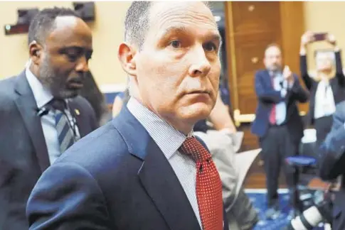  ?? AP ?? EPA head Scott Pruitt leaves after testifying before the House Energy and Commerse subcommitt­ee hearing in April.