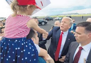  ?? SAUL LOEB/AFP/GETTY IMAGES ?? President Donald Trump greets supporters at Tampa Internatio­nal Airport on Tuesday. Trump came to support U.S. Rep. Ron DeSantis for governor and the Senate campaign of Gov. Rick Scott.