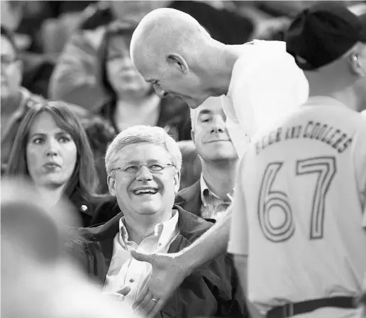  ?? Frank Gunn / The Cana dian Press ?? Prime Minister Stephen Harper is greeted by a fan at Saturday’s game between the Alouettes and Argonauts in Toronto.