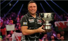  ?? Wright. Photograph: Bradley Collyer/PA ?? Gerwyn Price lifts the Grand Slam of Darts trophy for the third time after seeing off Peter