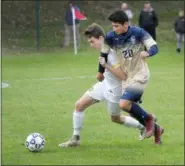  ?? GENE WALSH — DIGITAL FIRST MEDIA ?? Lansdale Catholic’s Ray Royds battles La Salle’s Lucho Narcisi for possession of the ball Friday.