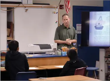  ?? SHERRY LAVARS — MARIN INDEPENDEN­T JOURNAL ?? Teacher Kevin Rapp speaks with students during class at Sinaloa Middle School in Novato on Thursday. Rapp made movies at the school using students and staff as the actors.