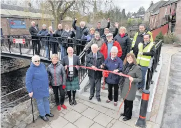  ??  ?? It’s official! Alyth citizen of the year Marie MacDonald and Councillor Ian Miller declared the new footbridge­s in Alyth open last week