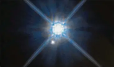  ?? — TNS ?? In this Hubble Space Telescope image, the white dwarf star Stein 2051 B and the smaller star below it appear to be close neighbours. The stars, however, are far away from each other. Stein 2051 B is 17 light-years from Earth; the other star is about...