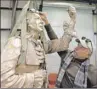  ?? AP PHOTO ?? In this March 26, 2014 file photo, Andy Davis places the glasses on the head of the status of Patrick Henry at The Inferno Art Foundry in Union City, Ga.