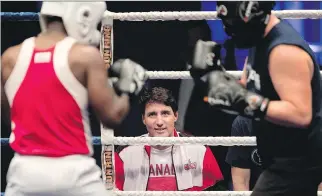  ?? ALLEN McINNIS ?? Prime Minister Justin Trudeau coaches Ali Nestor, left, as he fights Pascal Lepine during a charity boxing match benefiting École de la relève in Montreal on Wednesday.
