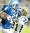  ?? SUN-SENTINEL FILE PHOTO ?? In this undated photo, Dillard running back TrabisWard, left, gives John Carr the stiff arm during a Class 5A high school playoff game where St. Thomas Aquinas played Dillard High at Lockhart Stadium in Fort Lauderdale.