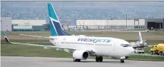  ?? JEFF MCINTOSH / THE CANADIAN PRESS ?? WestJet pilots are in a strike position, prompting rival Air Canada to expand capacity on key routes.