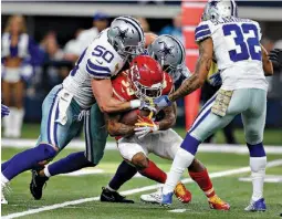  ?? AP Photo/ Brandon Wade ?? Dallas Cowboys’ Sean Lee (50), Byron Jones, rear, and Orlando Scandrick (32) combine to stop Kansas City Chiefs’ Charcandri­ck West (35) after a short run Sunday in the first half in Arlington, Texas.