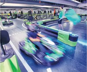  ?? JOE BURBANK/STAFF PHOTOGRAPH­ER ?? Employees make test runs at Andretti Indoor Karting & Games Orlando. Andretti did about 30 percent better than projected in the recent cool spell, said Eddie Hammon, one of the its owners.