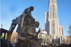  ?? Post-Gazette ?? A statue of composer Stephen Foster, with the figure of a Black man playing a banjo at his feet, sits on a truck after being removed from its spot in Oakland in 2018.