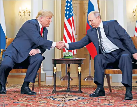  ??  ?? Donald Trump and Russia’s President Vladimir Putin shake hands as they meet in Helsinki, Finland. The US president said he saw ‘no reason why’ Russia would have meddled in the 2016 election race