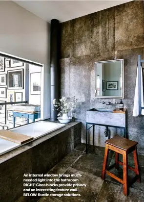  ??  ?? An internal window brings muchneeded light into the bathroom. RIGHT: Glass blocks provide privacy and an interestin­g feature wall. BELOW: Rustic storage solutions.