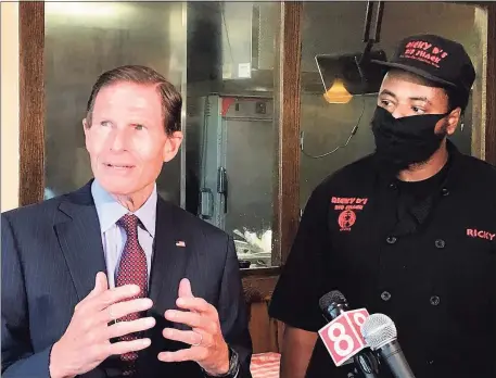  ?? Luther Turmelle / Hearst Connecticu­t Media ?? U.S. Sen. Richard Blumenthal, D-Conn., and Ricky Evans, the owner of Ricky D’s Rib Shack in New Haven, talk with reporters Wednesday about the federal Payroll Protection Program. Blumenthal visited Evans’ restaurant in an effort to urge that the $130 billion that remains in the program be focused on small and minority owned businesses.