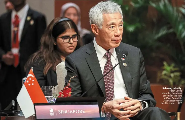  ?? — afp ?? Listening intently: Hsien loong attending the retreat session at the 43rd ASEAN Summit in Jakarta last year in this file photo.