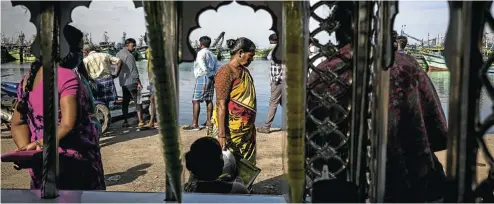  ?? Picture: Anindito Mukherjee/Bloomberg ?? Fishermen gather to auction their catch after returning from a fishing trip, at the harbour in Chennai, India, this week.