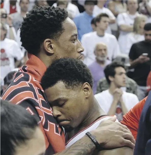  ?? FRANK GUNN/THE CANADIAN PRESS ?? Toronto Raptors guard DeMar DeRozan, left, hugs teammate Kyle Lowry after their team lost the Eastern Conference final to the Cleveland Cavaliers Friday in Toronto. Cleveland won the series 4-2 and will face either Oklahoma City or Golden State for the...