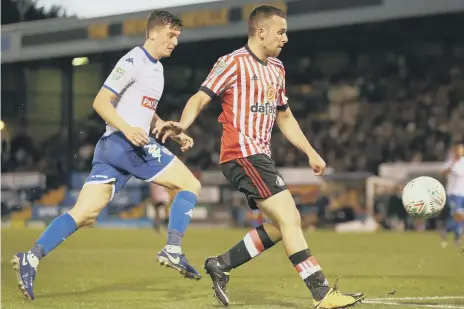  ??  ?? George Honeyman chips home Sunderland’s winner against Bury.