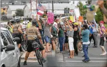  ?? RALPH BARRERA / AMERICAN-STATESMAN ?? Authoritie­s keep protesters a safe distance away as President Donald Trump’s motorcade arrives Aug. 29 at the Texas Department of Public Safety in Austin.