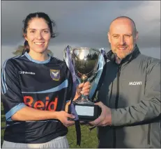  ??  ?? Badenoch captain Zoe Reid receives the National Division Championsh­ip Trophy from Ian Roberts of Mowi.