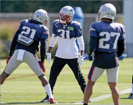  ?? MATT STONE — BOSTON HERALD ?? Patriots defensive back Jonathan Jones (31) stretches during a preseason practice at Gillette Stadium this past summer.