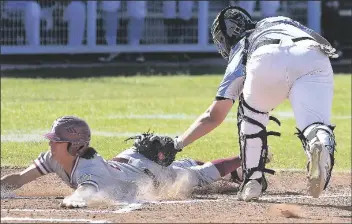  ??  ?? GILA RIDGE CATCHER GAGE WARNOCK (right) puts the tag on a sliding Mario Perez of Kofa who was trying to score from second base on a hit to right field by J.J. Ortiz in the top of the first inning of Tuesday afternoon’s game at Gila Ridge. The out was the third out of the inning.