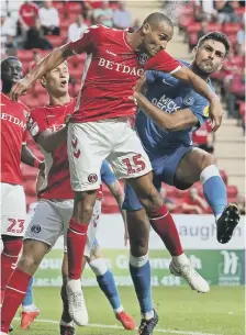  ??  ?? Posh star Ryan Tafazolli (right) challenges for a header at Charlton.