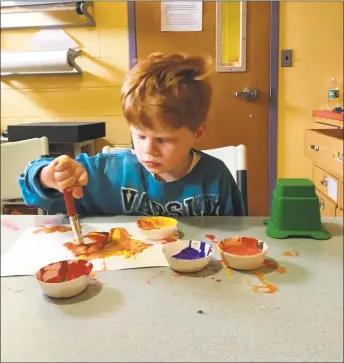  ?? Contribute­d photo ?? In an undated photo, Giant Steps student Max Garan uses painting to work on his fine motor skills.