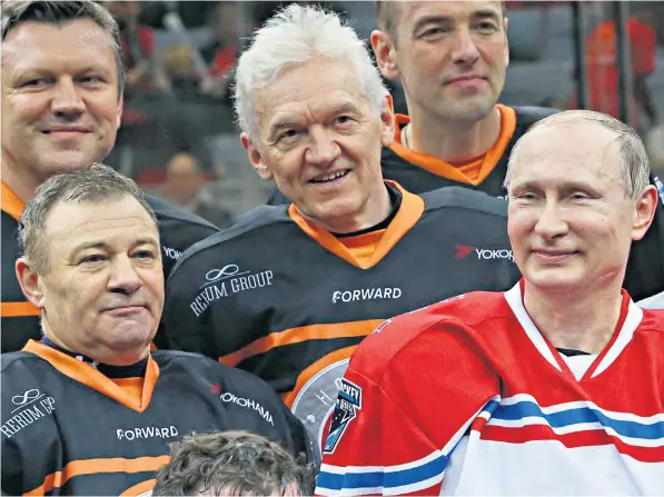  ?? ?? Vladimir Putin poses with billionair­e Russian businessme­n Arkady Rotenberg, left, and Gennady Timchenko, centre, during a Night Hockey League match in Sochi in 2015. Both men are included on Britain’s sanctions list