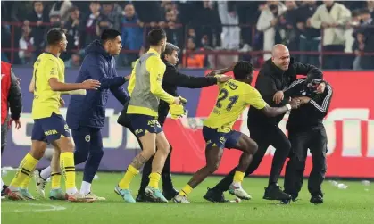  ?? ?? A fan (right) attacks Fenerbahce players after Trabzonspo­r’s 3-2 defeat. Photograph: EPA