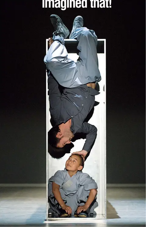  ??  ?? Ali Thabet and a novice monk showcase the versatilit­y of the wooden boxes used in the set design. — Ti Gong