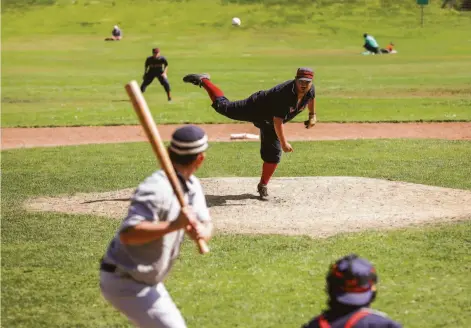  ?? Photos by Brontë Wittpenn / The Chronicle ?? Above, San Francisco Pelicans pitcher James Stapleton pitches against the Hayward Journals last month at Big Rec Ballfield in Golden Gate Park. Below, San Francisco Pacifics player Will Hartmann prepares to bat against the Dublin Aces at the park’s ballfield.