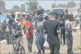  ?? TSVANGIRAY­I MUKWAZHI — THE ASSOCIATED PRESS ?? People are seen at a market in a poor township on the outskirts of the capital Harare, Monday.