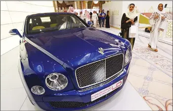  ??  ?? Visitors look at a Bentley luxury car displayed during the 2016 World Luxury Expo Riyadh 2016 held at the Ritz-Cartonhote­l in the capital Riyadh on March 30. (AFP)