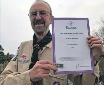  ?? T01_JeffAnders­on01 ?? Retired Oban group scout leader Jeff Anderson with his 30 years’ service to scouting certificat­e.