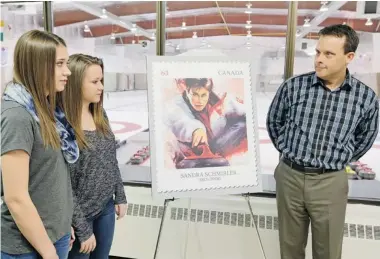  ?? TROY FLEECE/Leader-Post ?? Sara England, left, her sister Jenna and father Shannon England unveil a Sandra Schmirler stamp at the Callie Curling Club
in Regina on Feb. 3. Saturday marks the 16th anniversar­y of the late Schmirler’s Olympic gold-medal win.