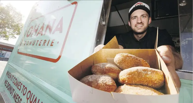  ?? IAN KUCERAK ?? Ohana Donuterie food truck co-owner Adam Biel shows some of his doughnut shop’s wares, which will be part of the What the Truck?!? season launch at the Alberta Legislatur­e on Saturday. There are a few new features at the festival this year, including a...
