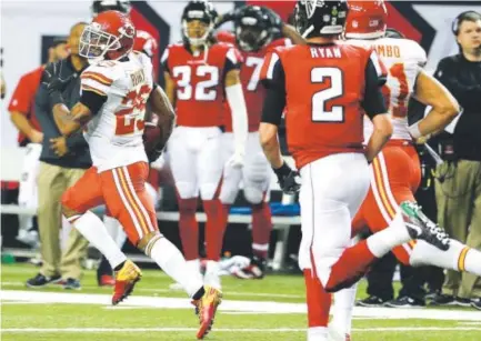  ??  ?? Kansas City Chiefs strong safety Eric Berry runs back an intercepti­on on an Atlanta Falcons two-point conversion attempt late in the fourth quarter Sunday at the Georgia Dome. Chuck Burton, The Associated Press